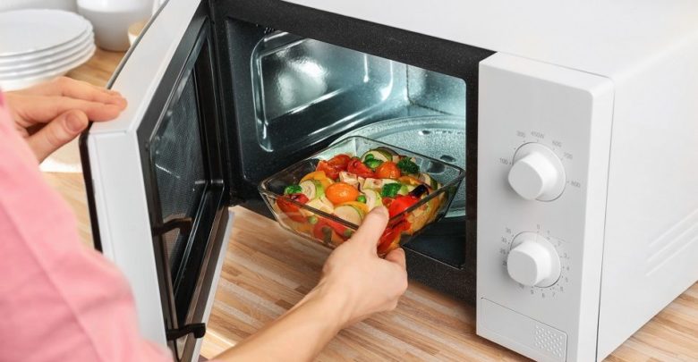 Can you stand in front of a microwave while cooking and is it safe?